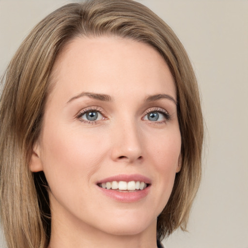 Joyful white young-adult female with medium  brown hair and green eyes