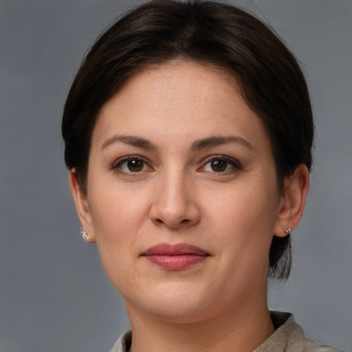 Joyful white young-adult female with short  brown hair and grey eyes