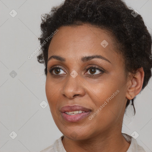 Joyful black adult female with short  brown hair and brown eyes