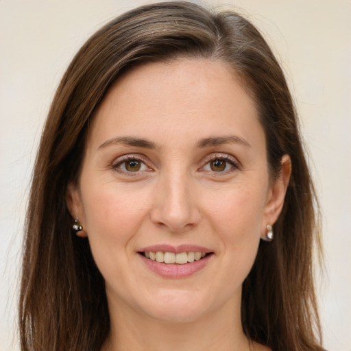 Joyful white young-adult female with long  brown hair and green eyes