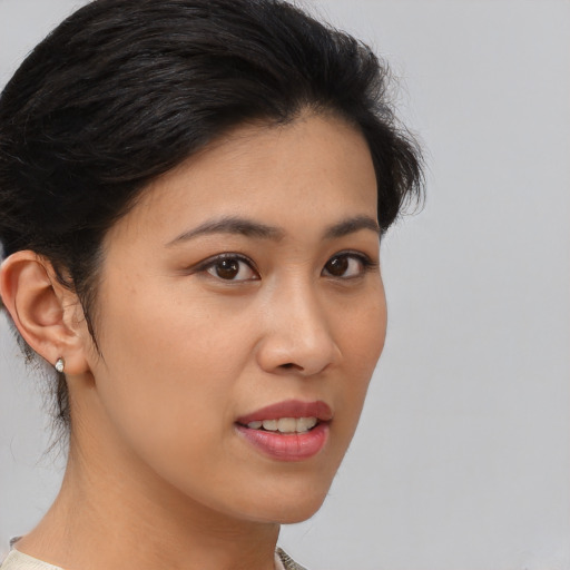 Joyful asian young-adult female with medium  brown hair and brown eyes