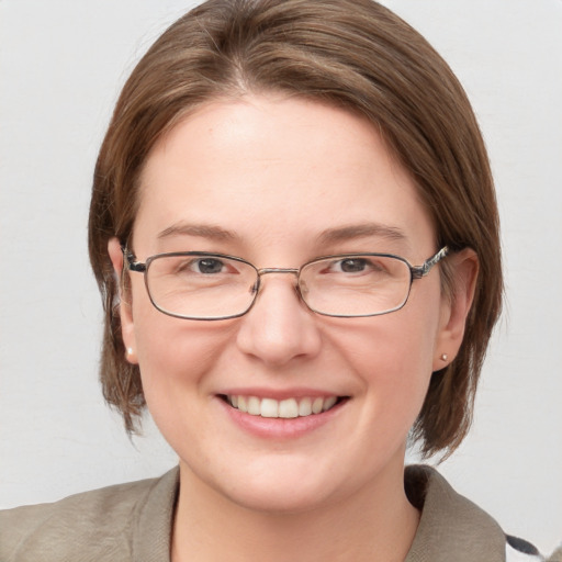 Joyful white adult female with medium  brown hair and blue eyes