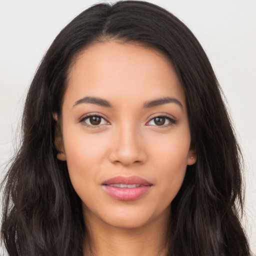 Joyful latino young-adult female with long  brown hair and brown eyes