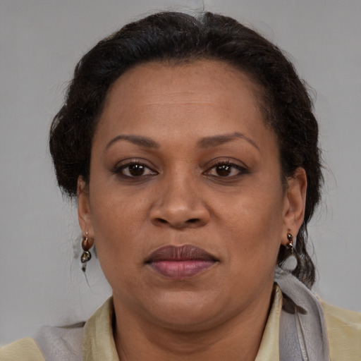 Joyful latino adult female with medium  brown hair and brown eyes
