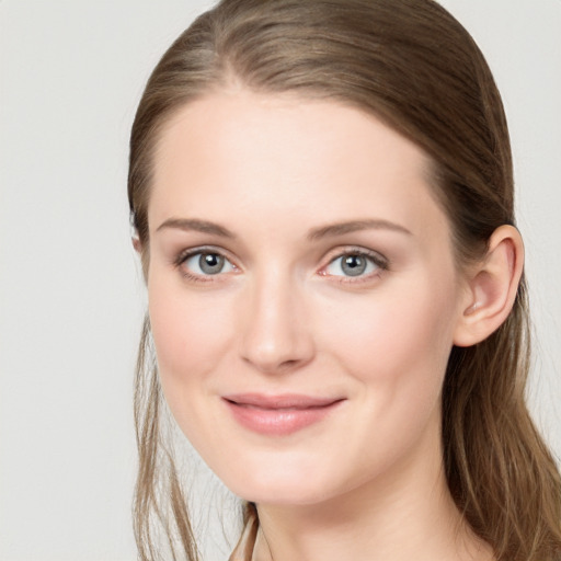 Joyful white young-adult female with long  brown hair and blue eyes