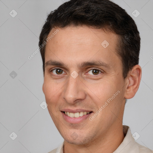 Joyful white young-adult male with short  brown hair and brown eyes