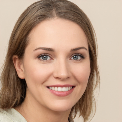 Joyful white young-adult female with medium  brown hair and green eyes