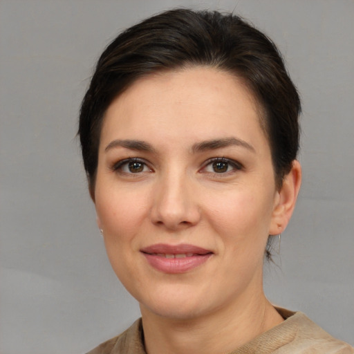 Joyful white young-adult female with medium  brown hair and brown eyes