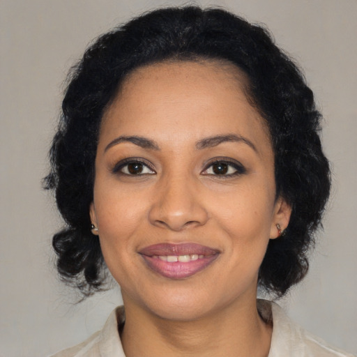 Joyful latino young-adult female with medium  black hair and brown eyes