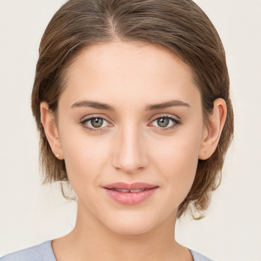 Joyful white young-adult female with medium  brown hair and green eyes