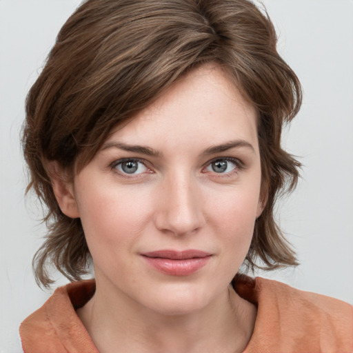 Joyful white young-adult female with medium  brown hair and blue eyes