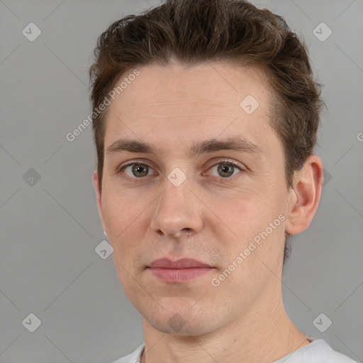 Joyful white adult male with short  brown hair and grey eyes