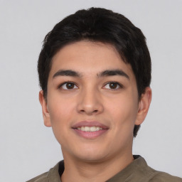 Joyful asian young-adult male with short  black hair and brown eyes