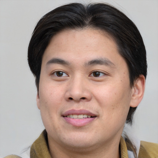 Joyful white young-adult male with medium  brown hair and brown eyes