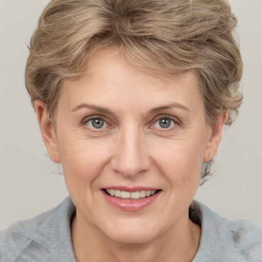 Joyful white adult female with medium  brown hair and grey eyes