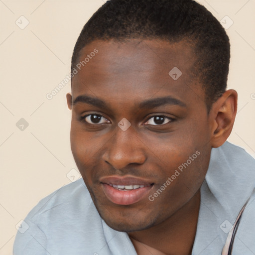 Joyful black young-adult male with short  brown hair and brown eyes