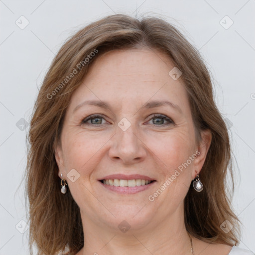 Joyful white adult female with medium  brown hair and grey eyes