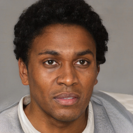 Neutral black adult male with short  black hair and brown eyes