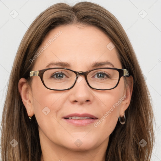 Joyful white adult female with long  brown hair and grey eyes