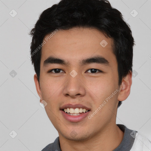 Joyful asian young-adult male with short  black hair and brown eyes