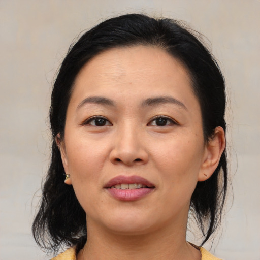 Joyful asian young-adult female with medium  brown hair and brown eyes