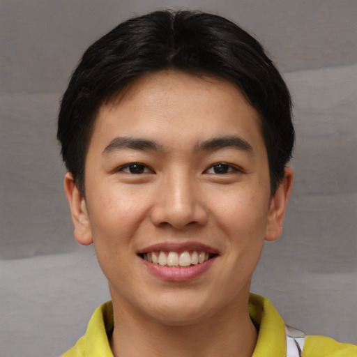 Joyful asian young-adult male with short  brown hair and brown eyes