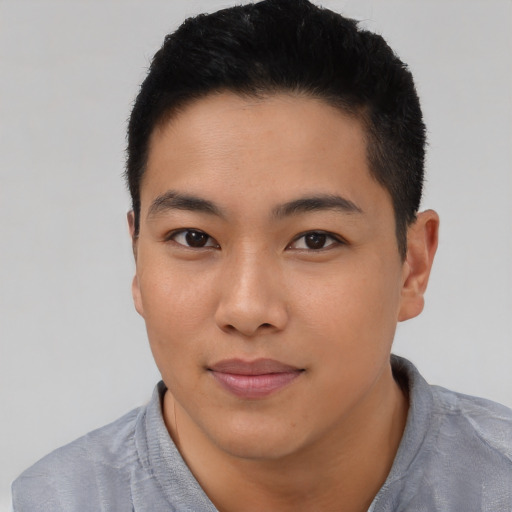 Joyful asian young-adult male with short  black hair and brown eyes