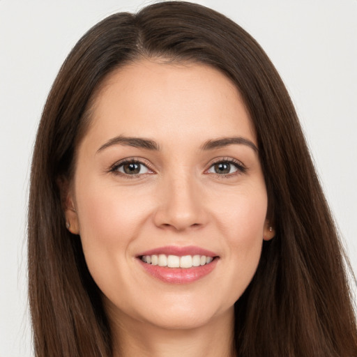 Joyful white young-adult female with long  brown hair and brown eyes