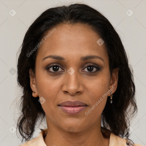 Joyful black adult female with medium  brown hair and brown eyes