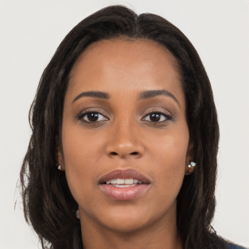 Joyful latino young-adult female with long  brown hair and brown eyes