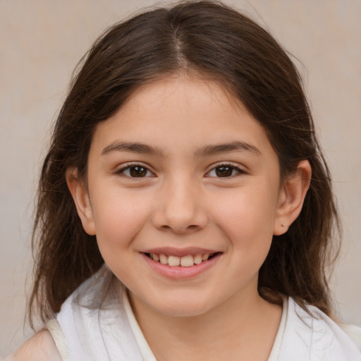 Joyful white child female with medium  brown hair and brown eyes