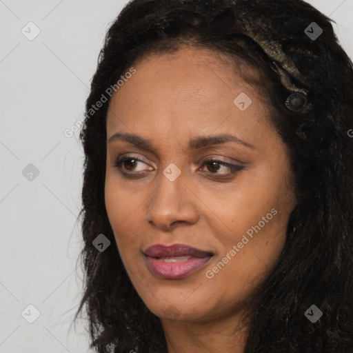 Joyful black young-adult female with long  black hair and brown eyes