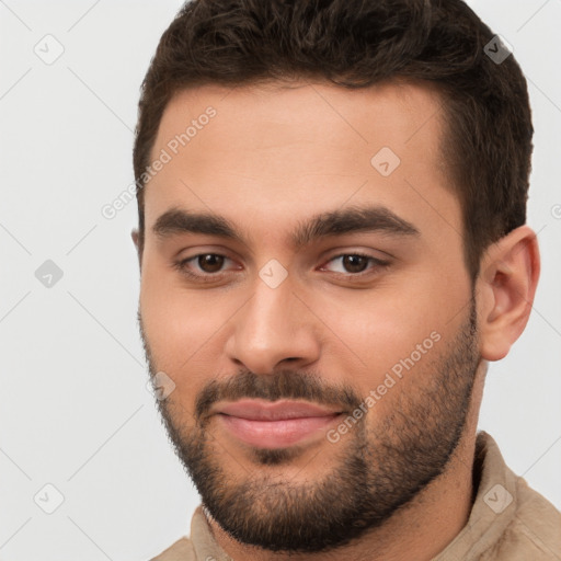 Joyful white young-adult male with short  brown hair and brown eyes