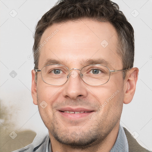 Joyful white adult male with short  brown hair and brown eyes