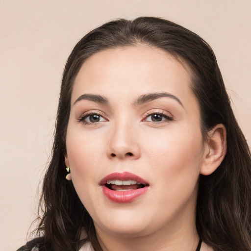 Joyful white young-adult female with long  black hair and brown eyes