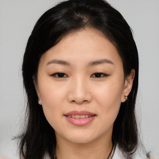Joyful asian young-adult female with long  brown hair and brown eyes