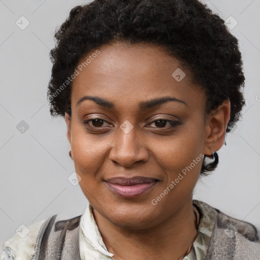 Joyful black young-adult female with short  brown hair and brown eyes