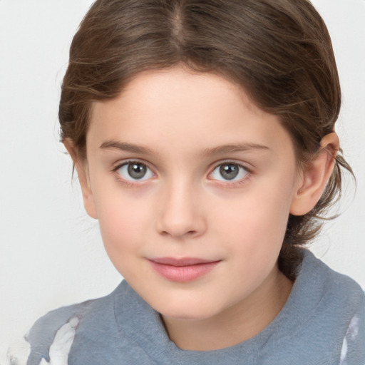 Joyful white child female with medium  brown hair and grey eyes