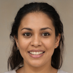 Joyful latino young-adult female with medium  brown hair and brown eyes