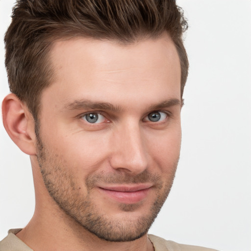 Joyful white young-adult male with short  brown hair and grey eyes