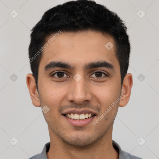 Joyful latino young-adult male with short  black hair and brown eyes