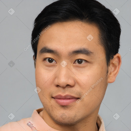 Joyful asian young-adult male with short  brown hair and brown eyes