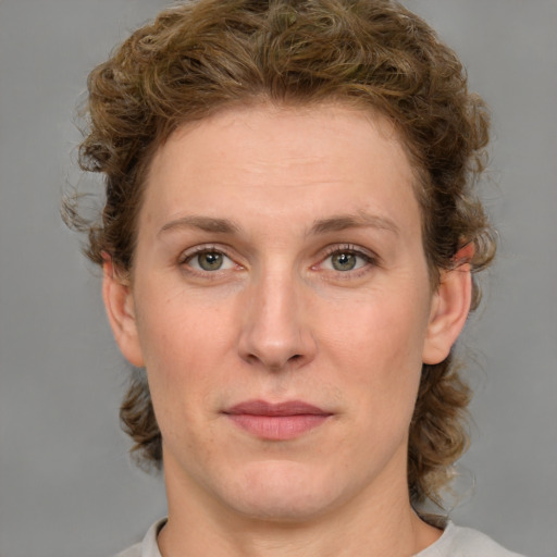 Joyful white young-adult female with medium  brown hair and green eyes