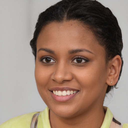 Joyful latino young-adult female with short  brown hair and brown eyes