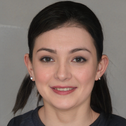 Joyful white young-adult female with medium  brown hair and brown eyes