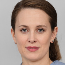 Joyful white adult female with medium  brown hair and grey eyes