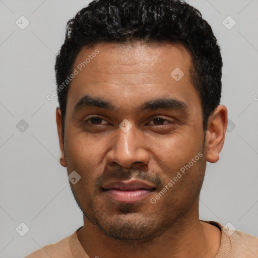 Joyful latino young-adult male with short  black hair and brown eyes