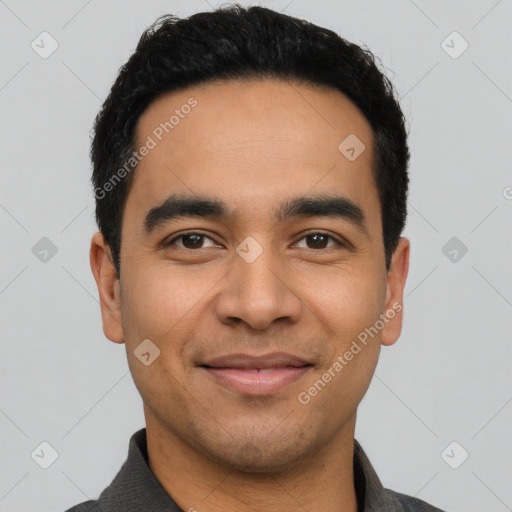 Joyful latino young-adult male with short  black hair and brown eyes