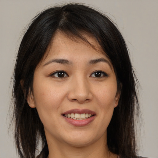 Joyful asian young-adult female with medium  brown hair and brown eyes