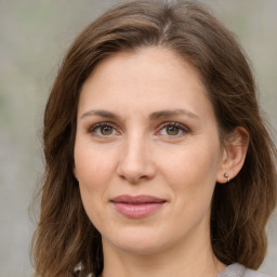 Joyful white young-adult female with medium  brown hair and green eyes